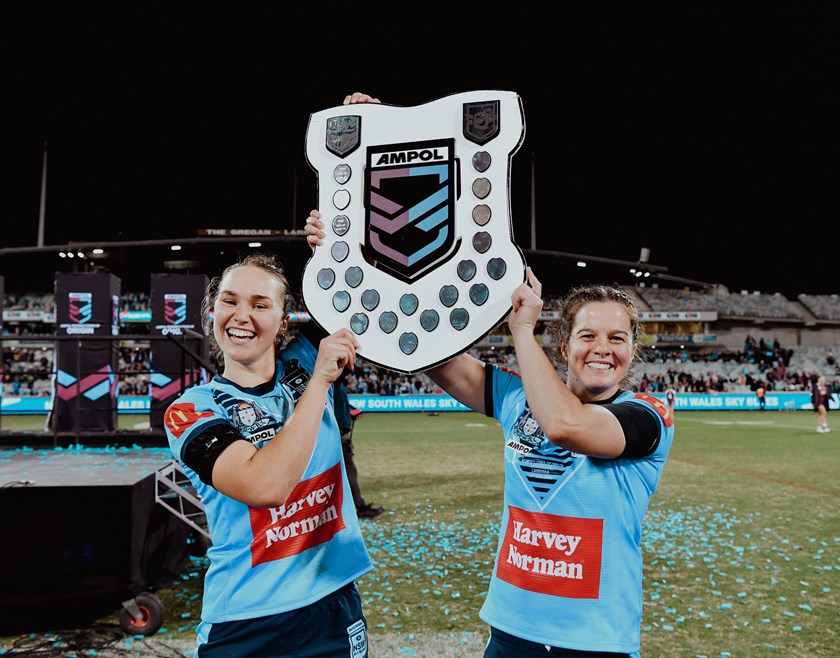 Rachael Pearson (right) lifts the State of Origin shield.