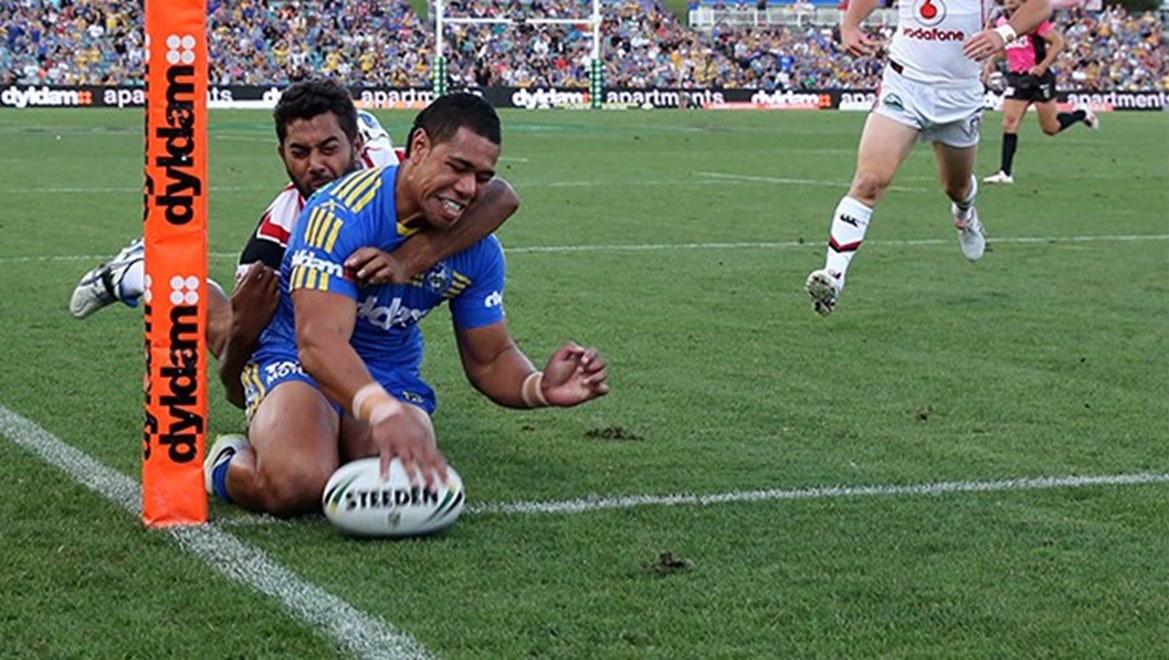Vai Tautai scores in the corner with Dane Neilson hanging on : NRL Rugby League - Round 1 Parramatta Eels v NZ Warriors at Parramatta Stadium Sunday the 9th of March 2014 . Digital Image by Grant Trouville Â© nrlphotos.com